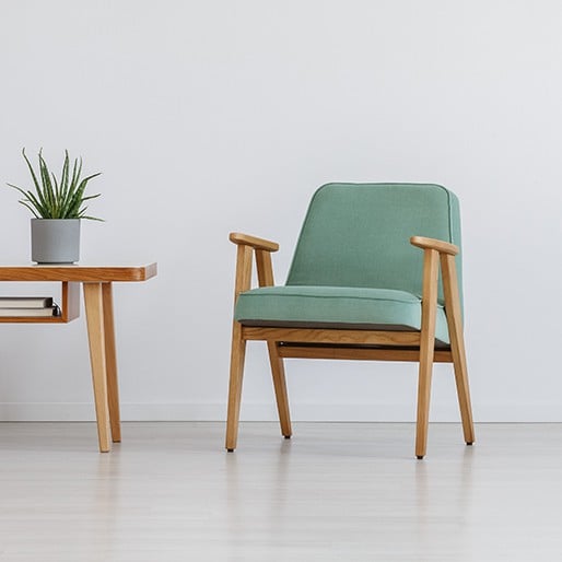 Wooden chair with green cushions