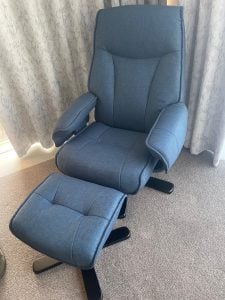 Upholstered grey recliner chair with foot stool in Tauranga