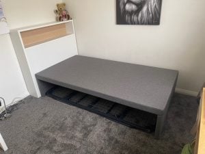 single bed with bookshelf bedhead in Tauranga
