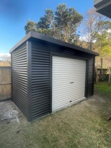 Graphite shed with white rollerdoor in Tauranga